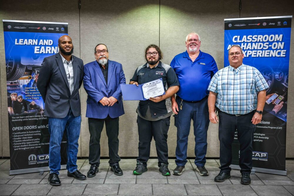 Native American student Camron Slaton (center) of Oklahoma State University Institute of Technology in Okmulgee, Oklahoma, is a recipient of one of three Mopar Career Automotive Program (CAP) scholarships. Shown in a recent ceremonial event, Slaton will receive up to $20,000 reimbursements for necessary tools and two years of tuition to become an automotive service technician.