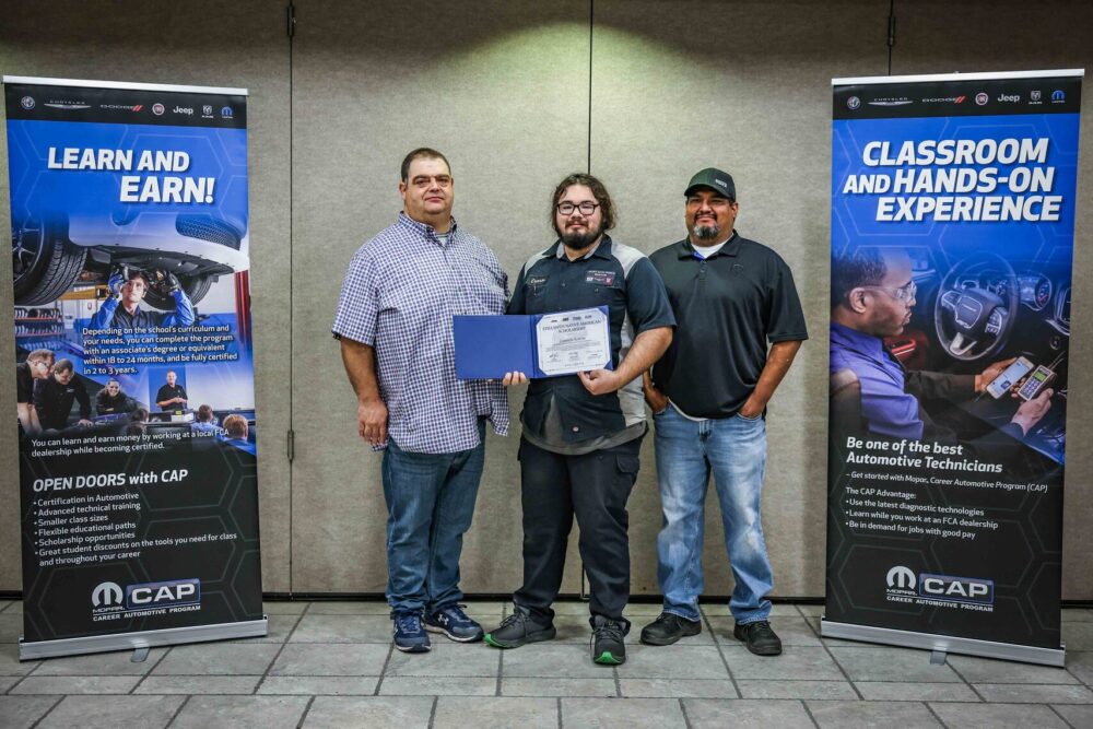 Native American student Camron Slaton (center) of Oklahoma State University Institute of Technology in Okmulgee, Oklahoma, is a recipient of one of three Mopar Career Automotive Program (CAP) scholarships. Shown in a recent ceremonial event, Slaton will receive up to $20,000 reimbursements for necessary tools and two years of tuition to become an automotive service technician.<br /> Shown from left to right: Bradley Cooper, Service and Parts Director, Crown Auto World, Bristow, OK; Camron Slaton, Scholarship Recipient, Crown Auto World, Bristow, Oklahoma; Victor Herrera, Student Mentor, Shop Foreman, Crown Auto World, Bristow, Oklahoma