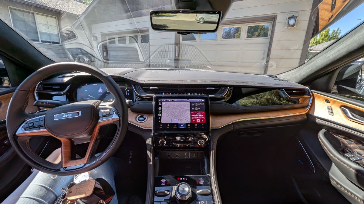 The wood and leather-clad interior of a 2024 Jeep Grand Cherokee 4xe Summit Reserve